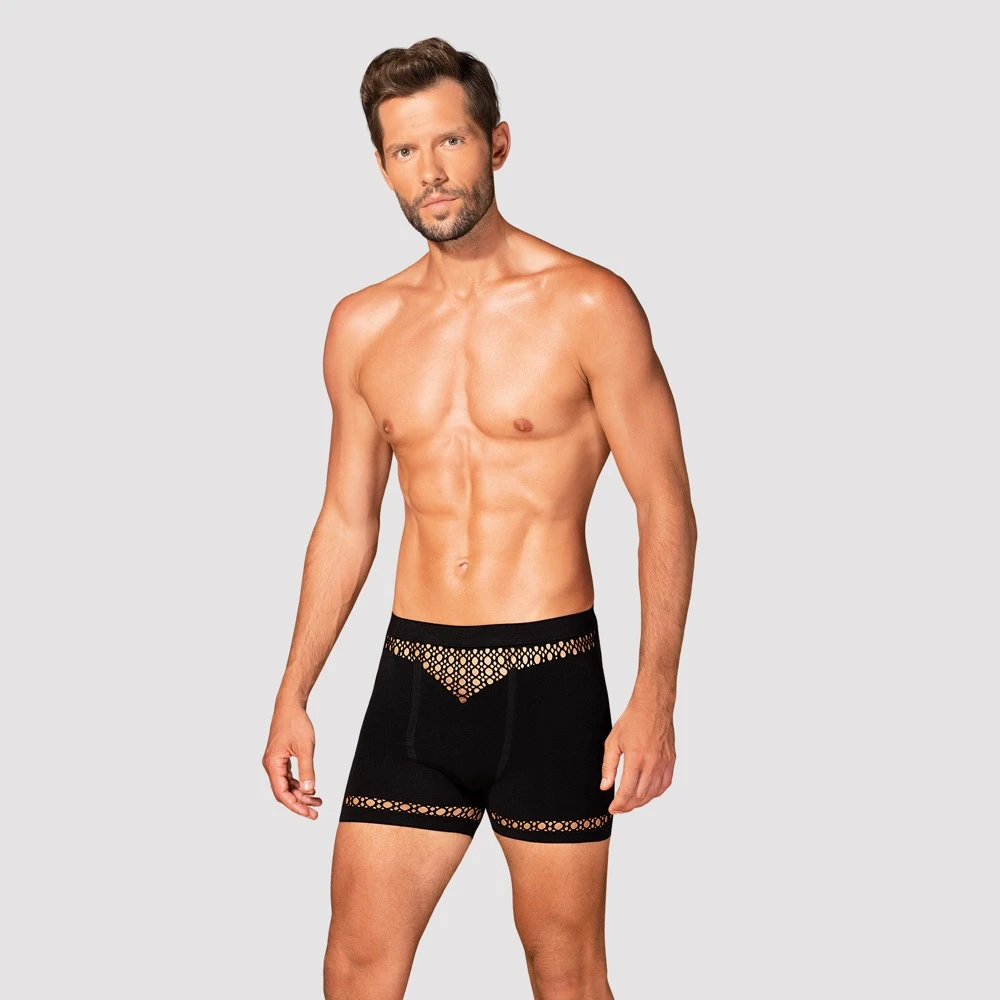 Obsessive Schwarze Pants mit hautdurchblitzenden Cut-outs in Netzoptik an Bund und Bein. Aus weichem Stretchmaterial mit bequemem Bundgummi.